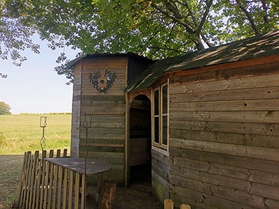 The cabin next to the pond from the outside